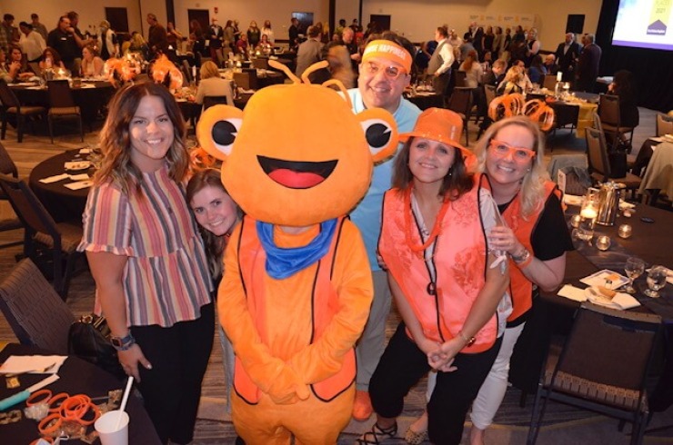 Cardinal CSD staff members and an Orange Frog mascot at the 2021 Des Moines Register Top Workplaces Celebration.