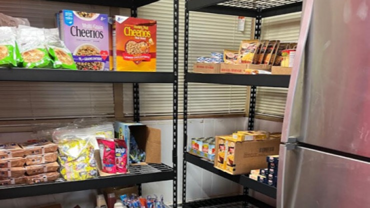 Cheerios and other dry goods on shelves at the Cardinal CSD community food pantry.